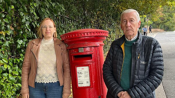 Claire and Nigel by a post box