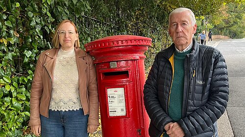 Claire Bonham and Nigel Dingley by a postbox on Highfield Hill